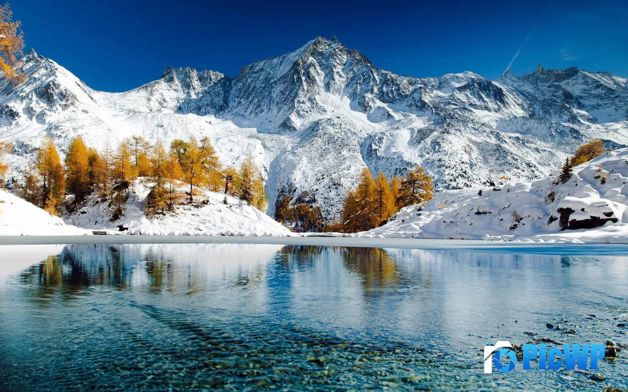 Clear Sky Winter Scene Snowy Mountains Frozen Lake Reflection 5K PC Wallpaper