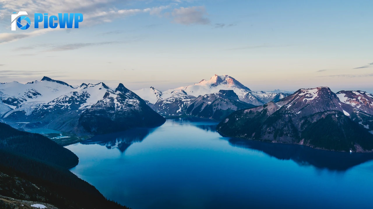 Blue lake surrounded by Snow-covered mountains 4K PC Wallpaper