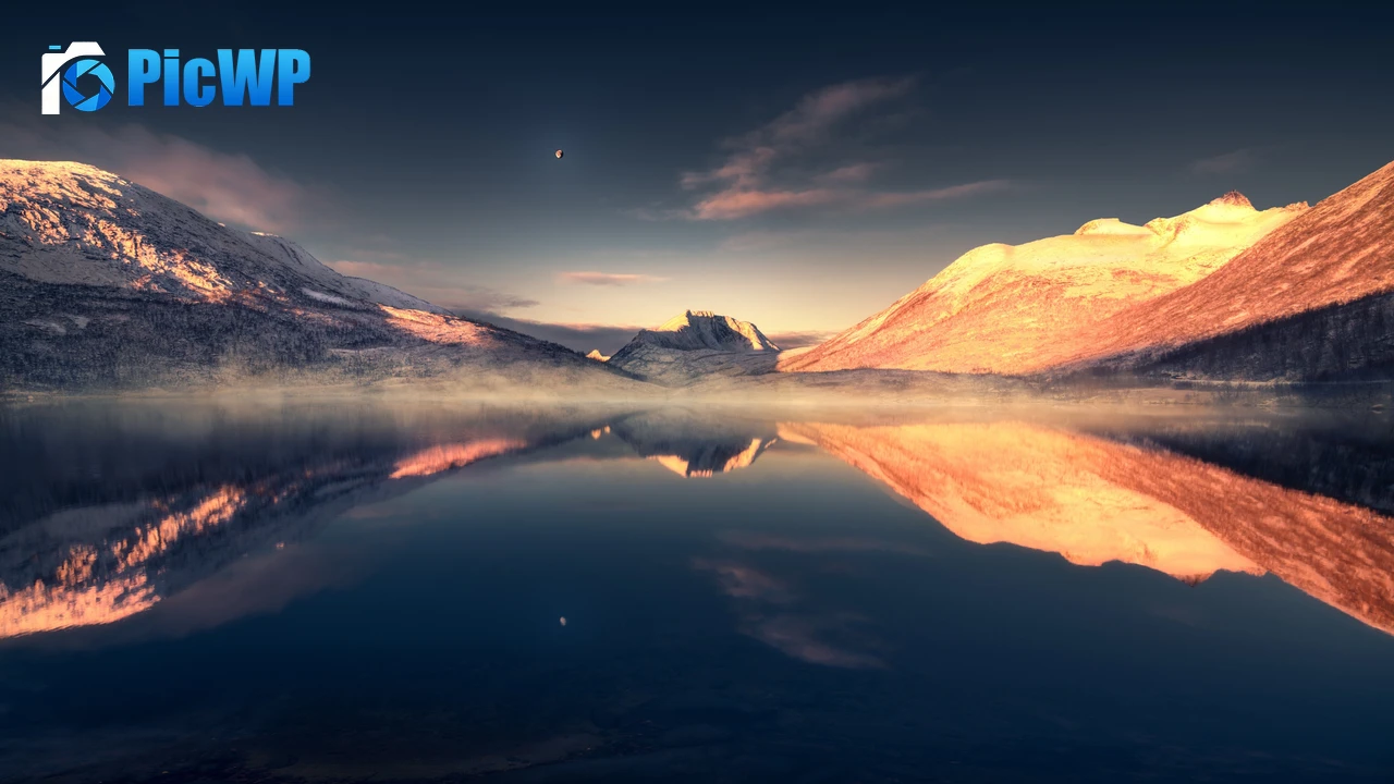 Calm lake surrounded by snow covered mountains 4K PC Wallpaper